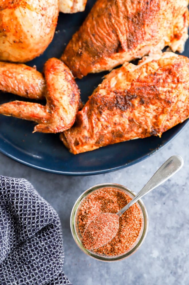 Smoked chicken on a plate with seasoning mixture