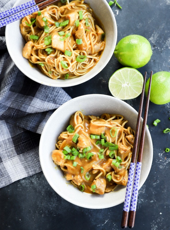 Curry udon noodles in bowls with chopsticks and green onion