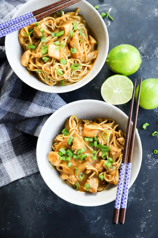 Curry udon noodles in bowls with chopsticks and green onion