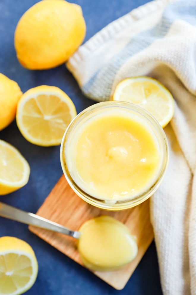 Lemons all around with lemon curd in a jar with a spoon