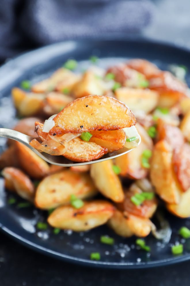 Spoonful of side dish with chives and salt