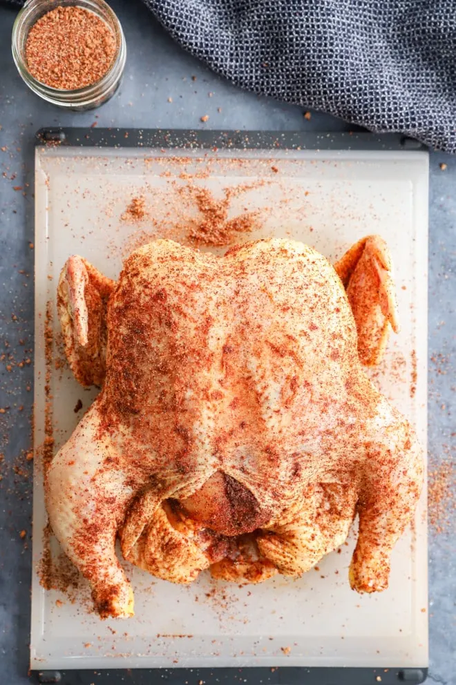 Ingredients for whole smoked chicken on cutting board