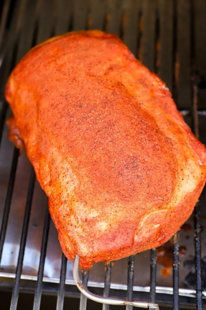 pork loin on a smoker with probe thermometer