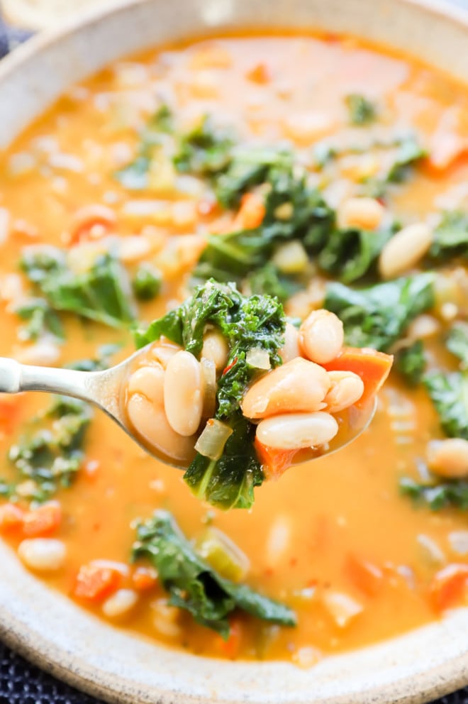 Spoonful of tuscan white bean soup with kale