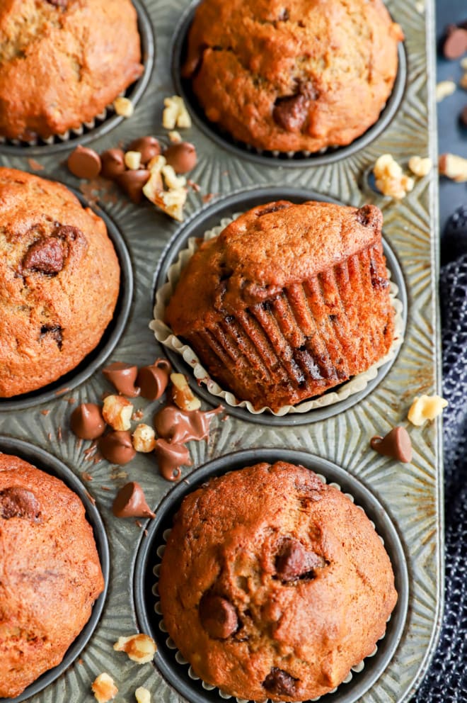 Banana bread muffins in tin with one on its side