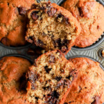 banana bread muffin cut in half with chocolate and nuts