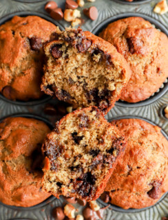 banana bread muffin cut in half with chocolate and nuts