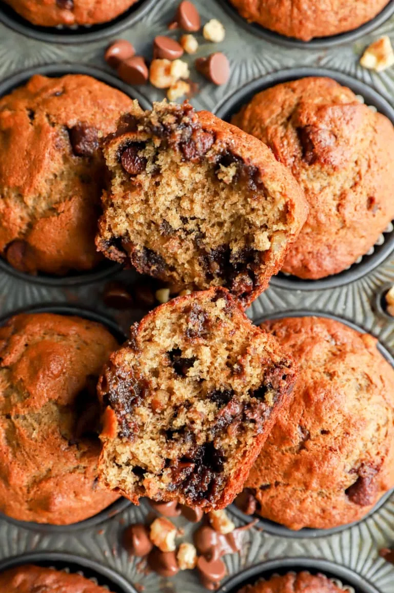 banana bread muffin cut in half with chocolate and nuts