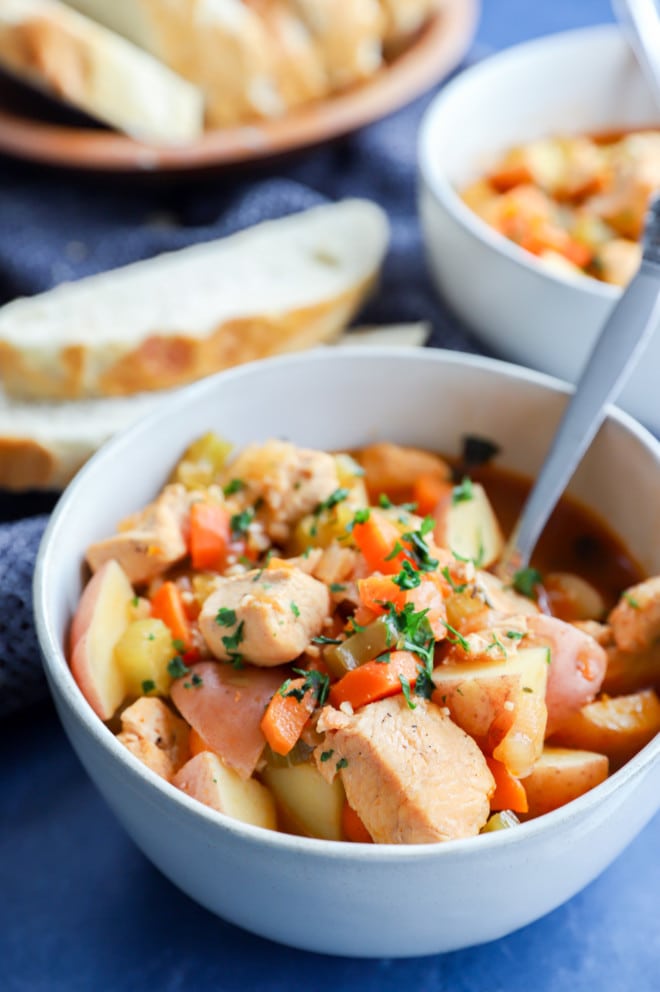 chicken soup in a bowl with fresh herbs