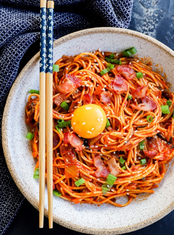 Kimchi udon in a bowl with egg yolk on top