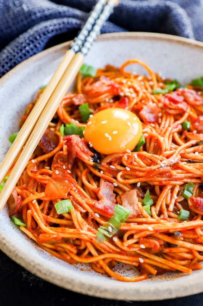 Bowl of easy noodles spicy with chopsticks and green onion