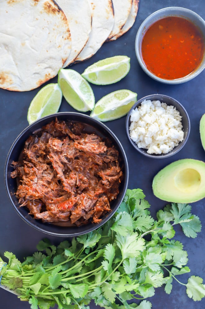 bowl of mexican shredded beef with fresh toppings