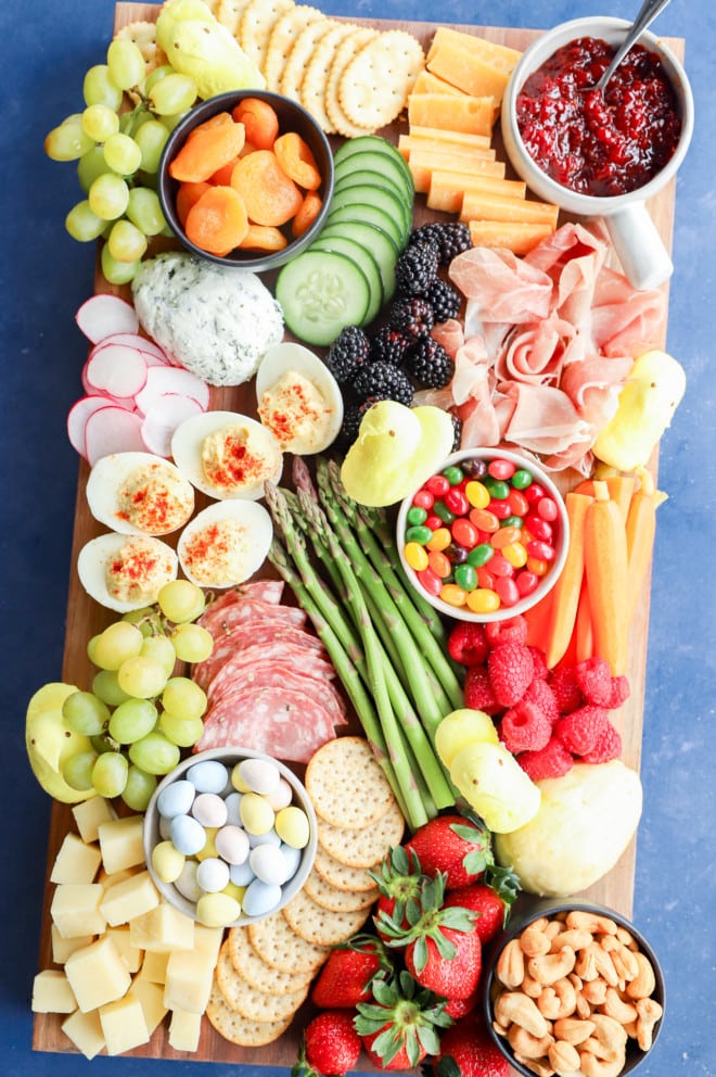 candies and treats for an easter celebration on an easter snack board