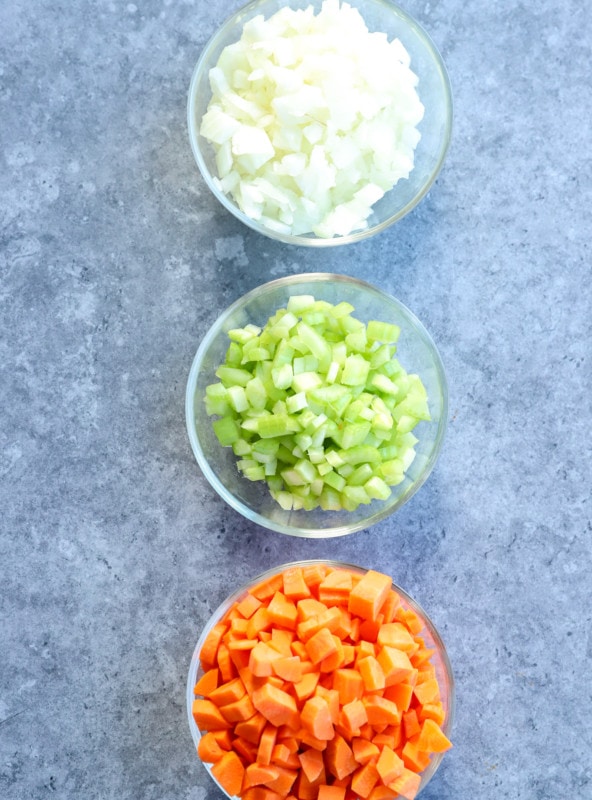 onions celery and carrots chopped up into bowls