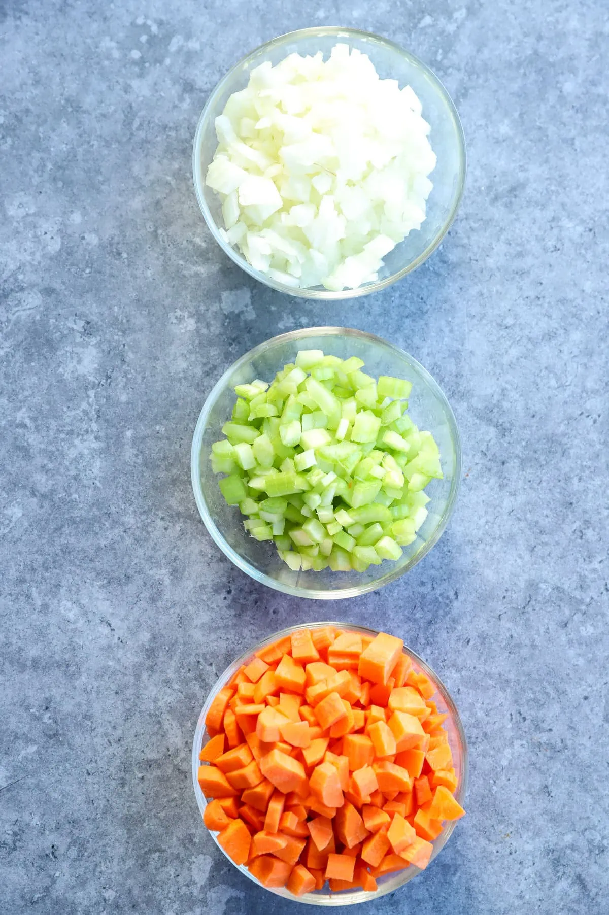 onions celery and carrots chopped up into bowls