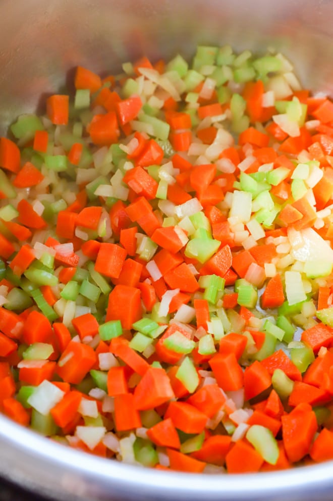 Sautéing celery, onion, and carrots for a mirepoix recipe