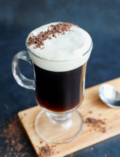 classic Irish coffee in clear mug with topping