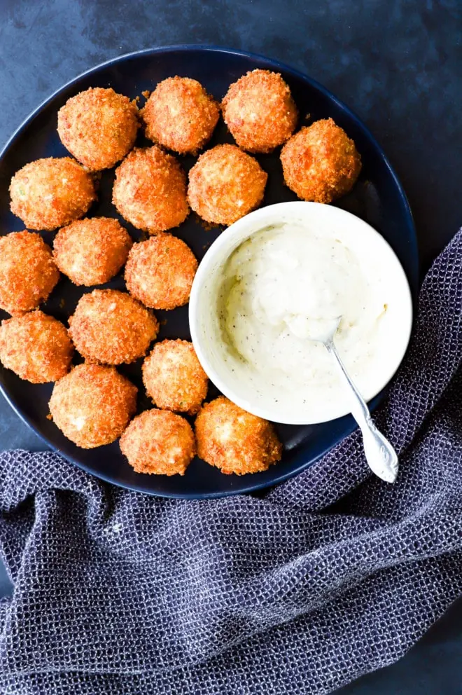 plate of crispy cheesy snacks with roasted garlic aioli