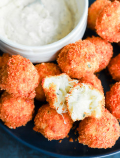 Potato cheese ball torn in half to show the gooey cheese inside