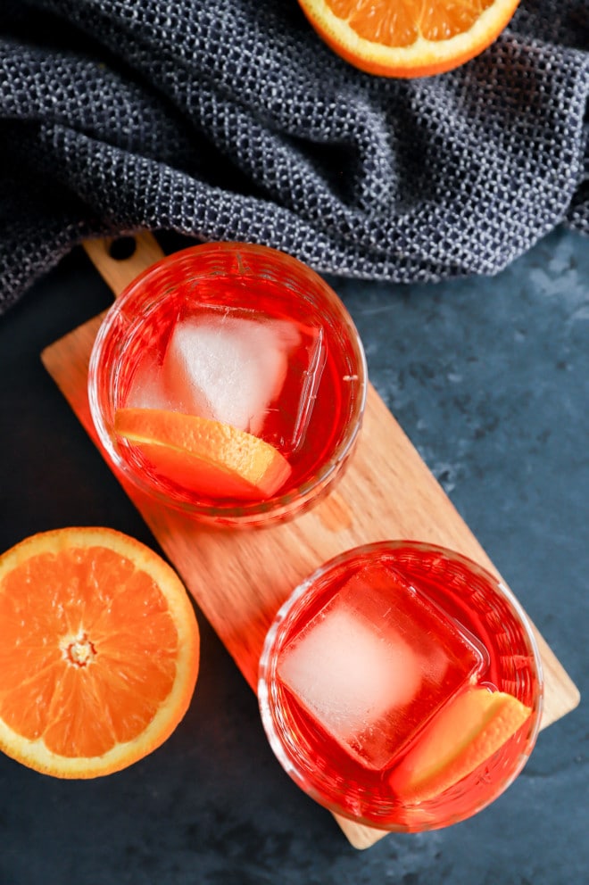 Aperol negroni in cocktail glasses with orange halves