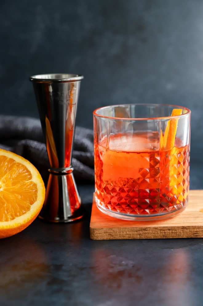Aperol negroni in a cocktail glass with jigger
