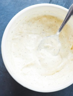 Creamy garlic aioli in a bowl with a spoon