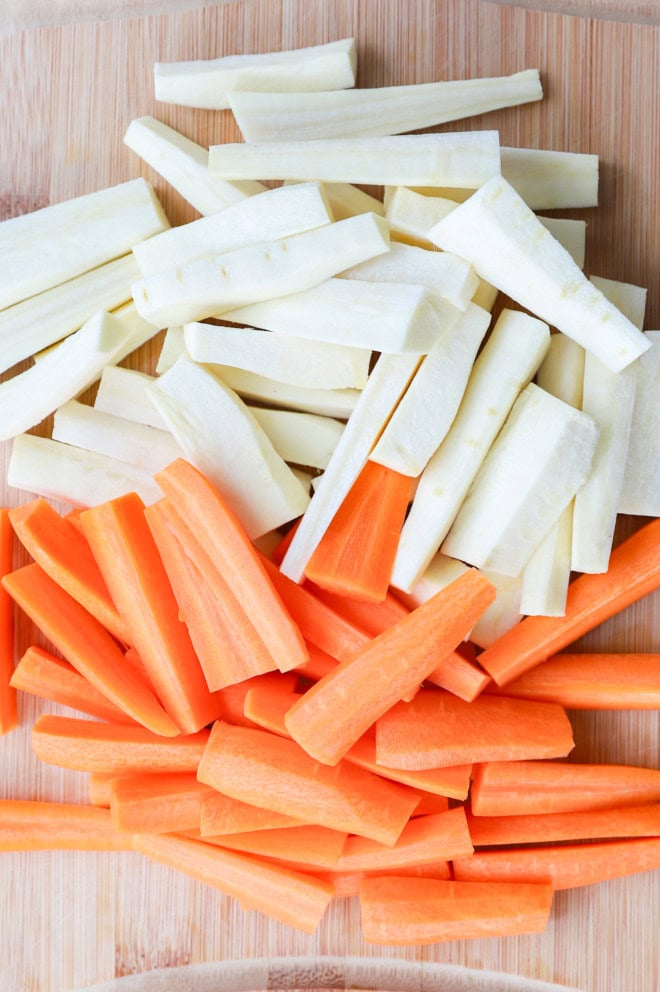 raw carrots and parsnips on cutting board