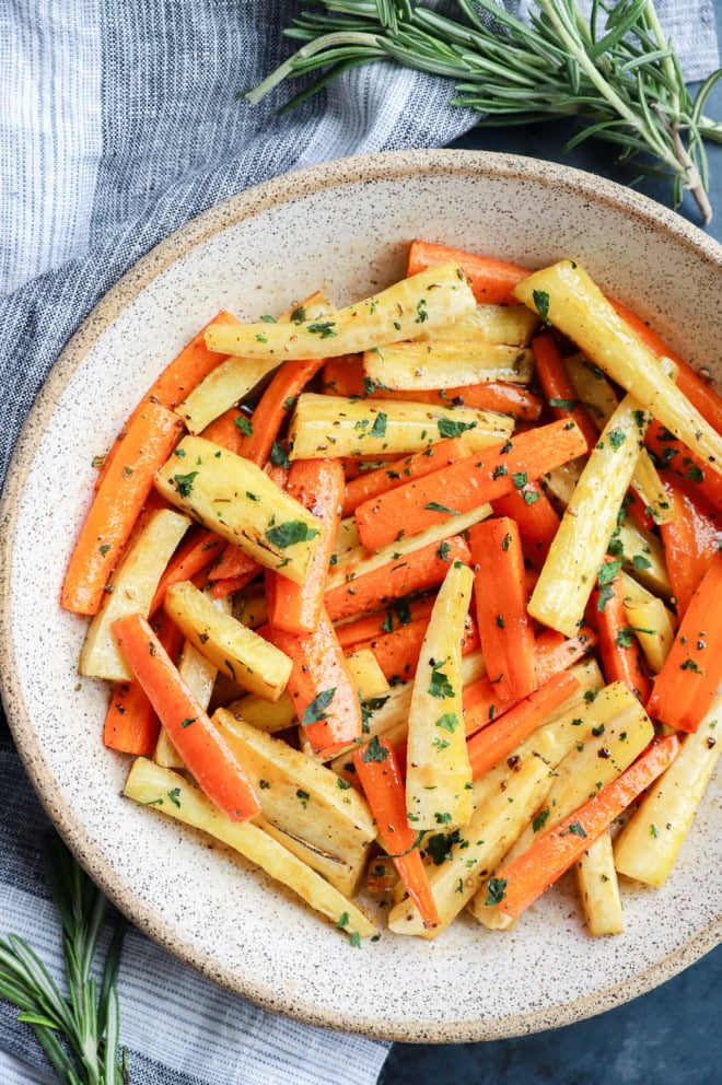 fresh parsley on top of honey glazed carrots and parsnips