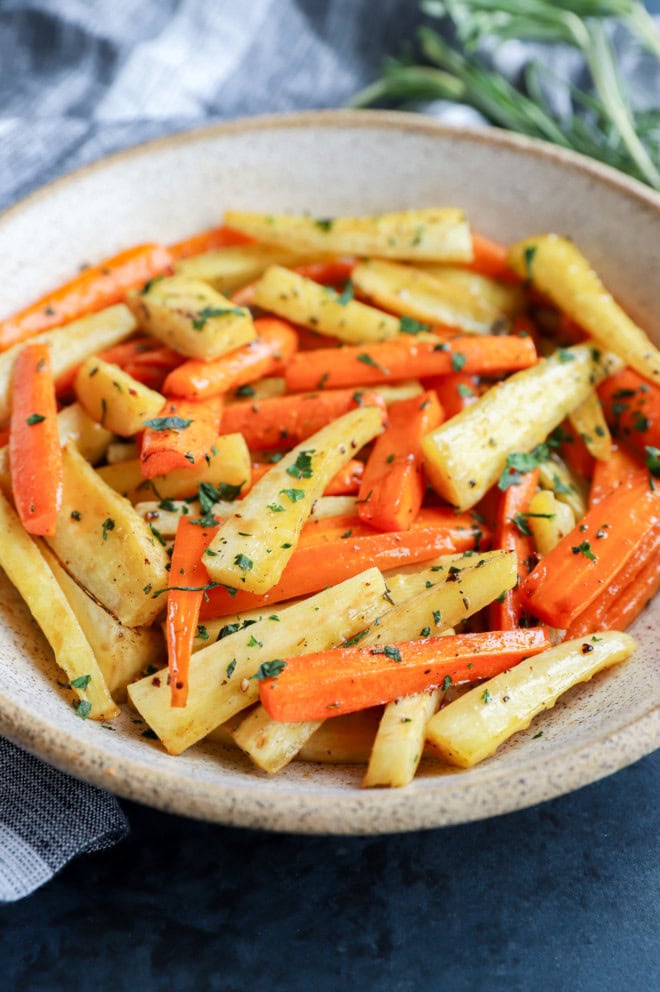 bowl of root vegetables with fresh parsley on top