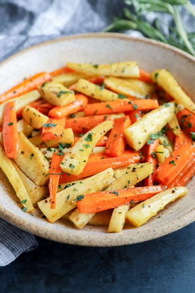 bowl of root vegetables with fresh parsley on top