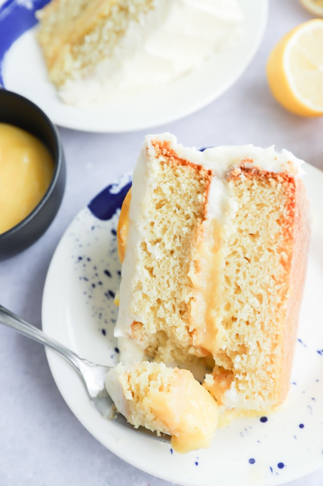 Fork taking a bit out of vanilla dessert with cream cheese frosting