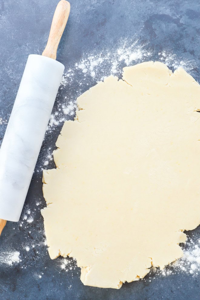 shortbread cookie dough rolled out with rolling pin