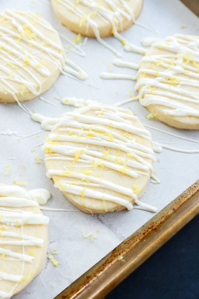 lemon shortbread cookies with white chocolate and lemon zest on top