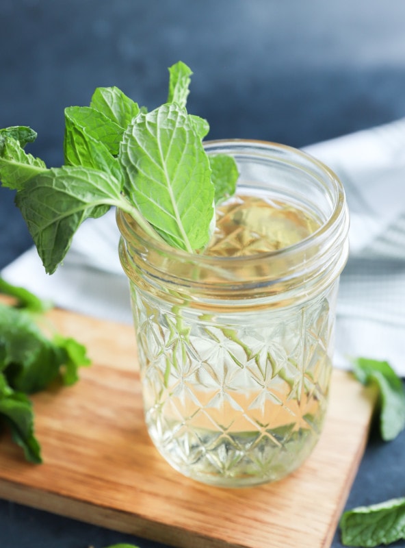 Fresh herbs in a jar of liquid sweetener homemade