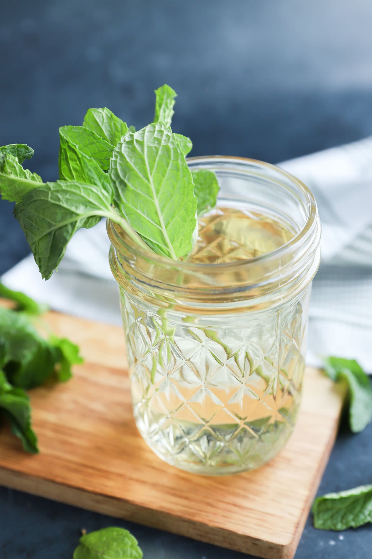 Fresh herbs in a jar of liquid sweetener homemade