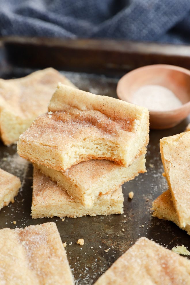 snickerdoodle bars in a stack with a bite taken out of one