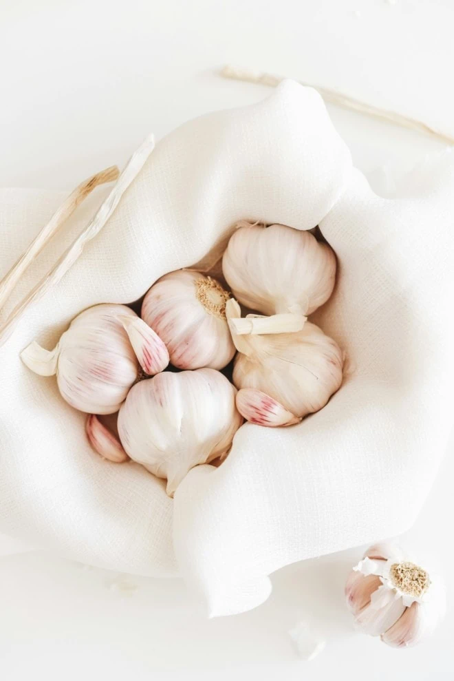 whole garlic heads in a linen bag