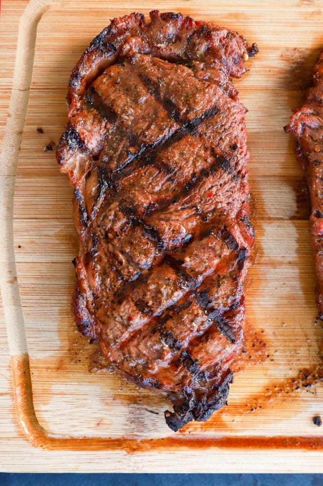 Grilled new york strip steak on a cutting board