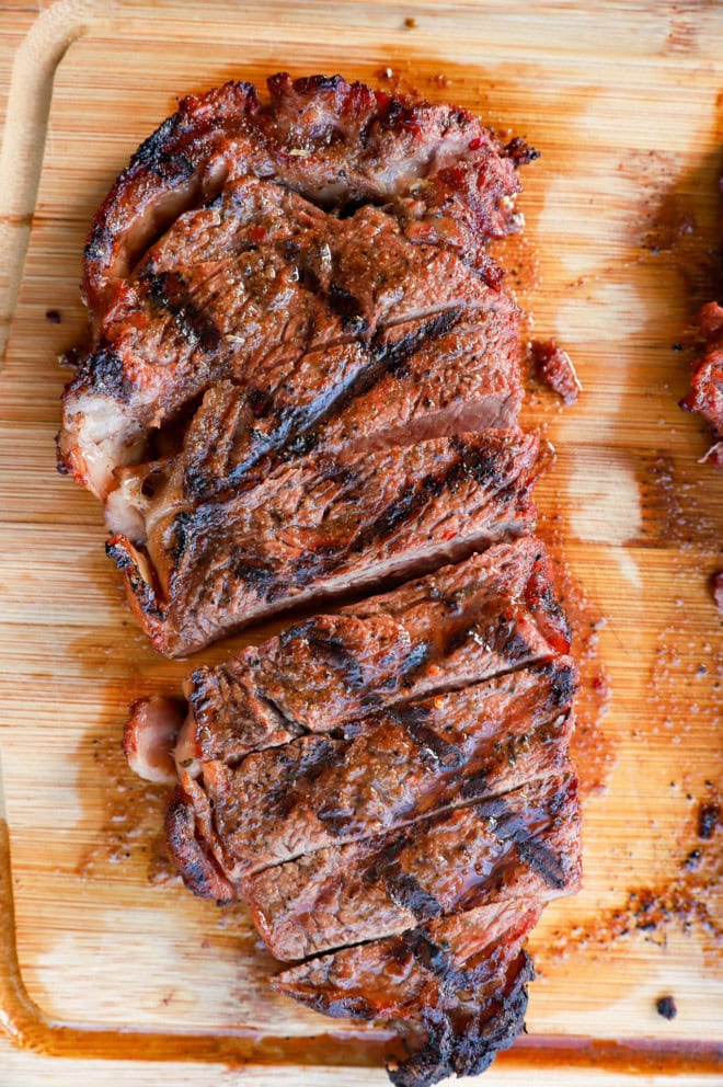 Sliced steak that has sat in a 3-ingredient steak marinade on cutting board