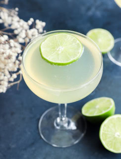 easy champagne drink in coupe glass with limes
