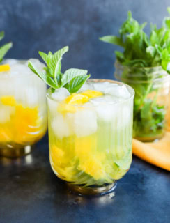 mango mojito in gatsby glasses with mint sprig garnish