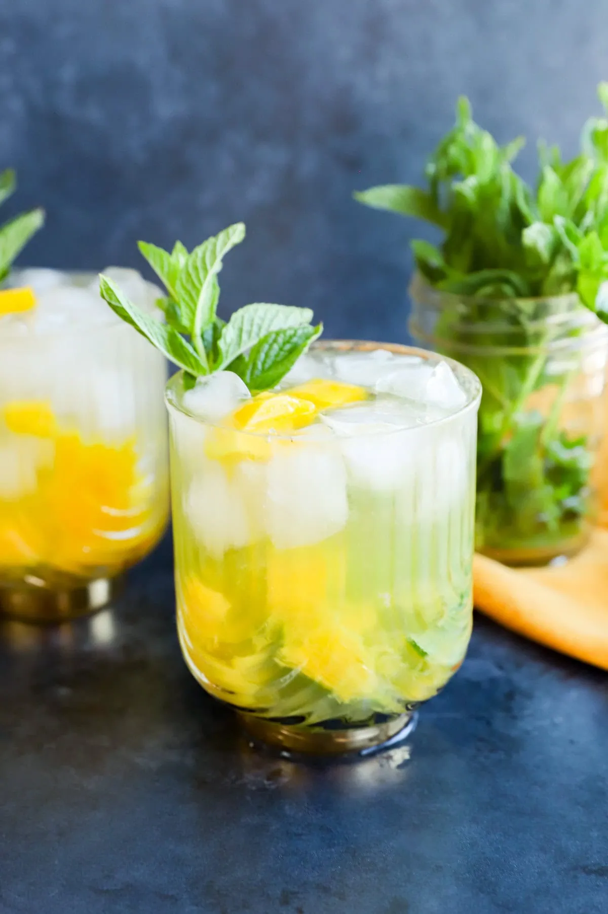 mango mojito in gatsby glasses with mint sprig garnish