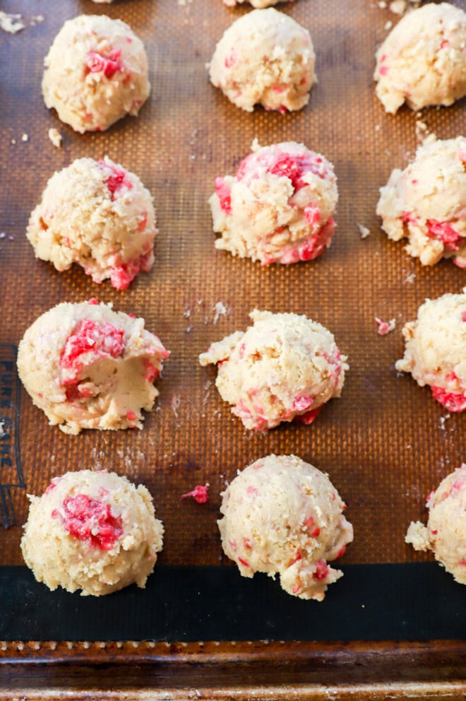 raw raspberry cheesecake cookie dough on baking sheet before baking in the oven
