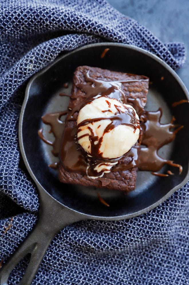 sizzling brownie in a hot skillet with ice cream and fudge sauce