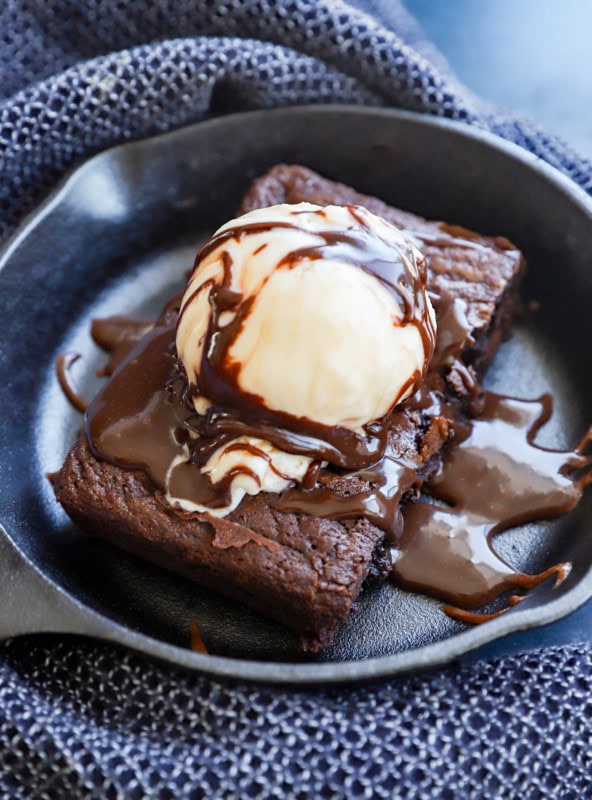 homemade baked chocolate treat served hot with ice cream and chocolate sauce