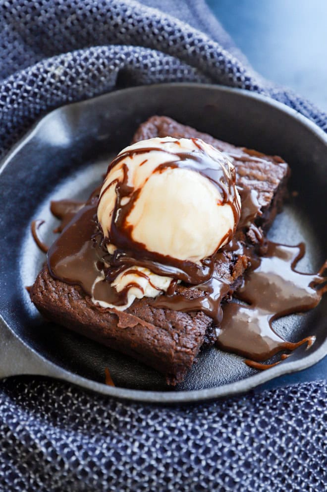 homemade baked chocolate treat served hot with ice cream and chocolate sauce