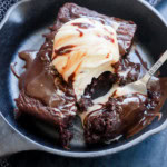 fork taking a bite out of a sizzling brownie ice cream sundae