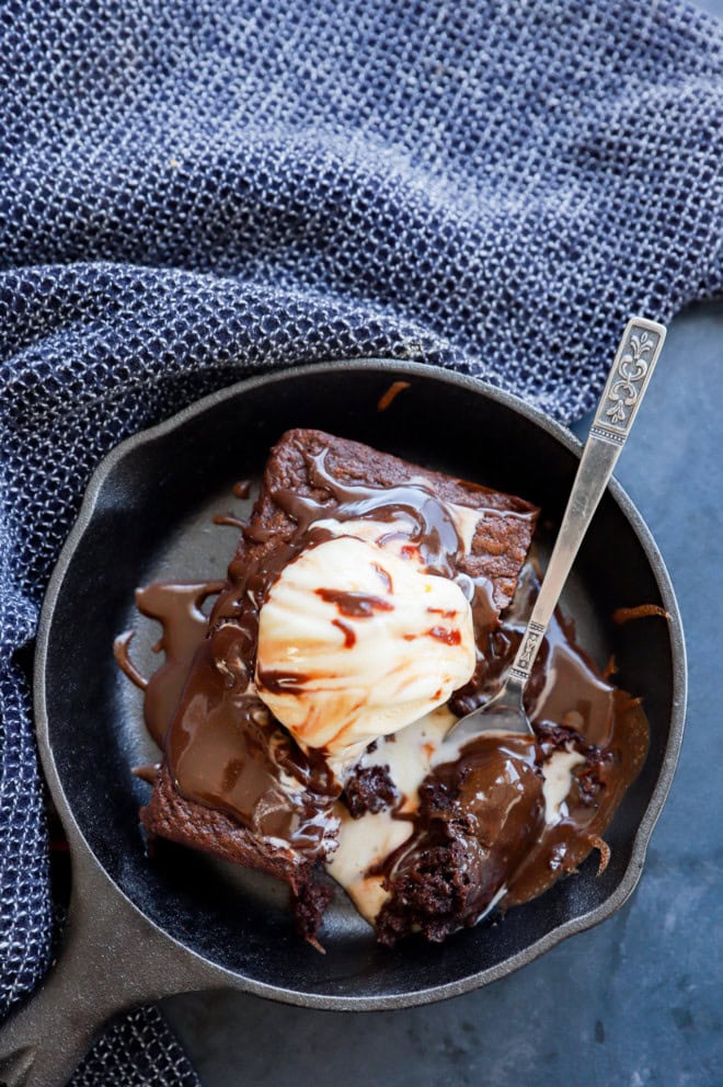 fork taking a bite out of chocolate baked treat in a skillet