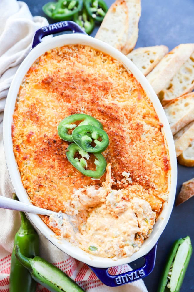 spoon in pan of baked cheese appetizer in pan