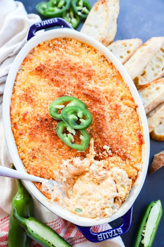 spoon in pan of baked cheese appetizer in pan